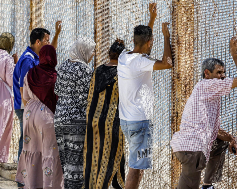 Hundreds gather near Ceuta border in anxious wait for missing loved ones as 70,000 people from estimated 72,000 had been returned to Morocco