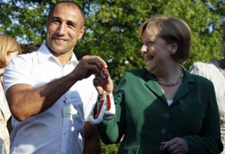 Angela Merkel receives boxing gloves as present from Arthur Abraham 