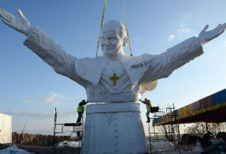 Top of the world's biggest statue of Pope John Paul II lifted into place in his native Poland