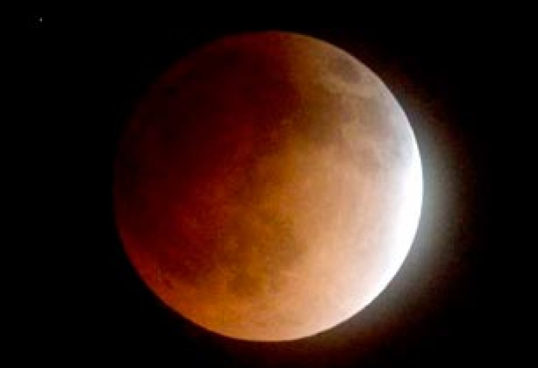 Blood moon rises: Incredible pictures of total lunar eclipse reveal stunning red disc illuminating the night sky