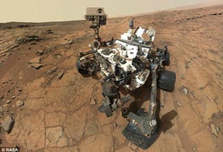 Hello down there: NASA Mars Orbiter takes picture of Curiosity rover as it probes isolated Martian hill