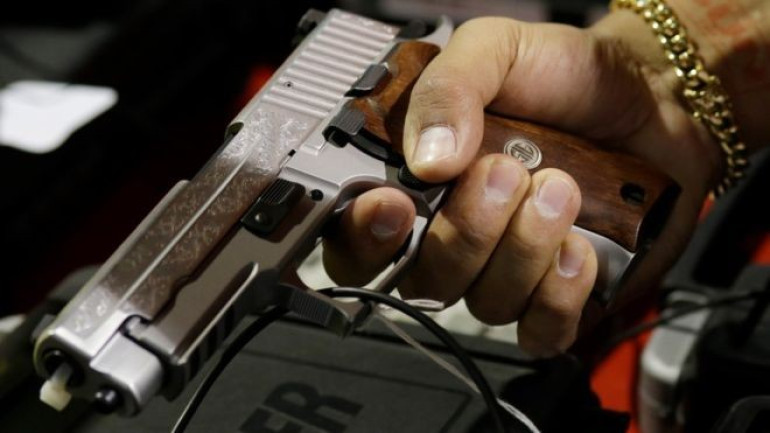 Facebook bans private gun ads