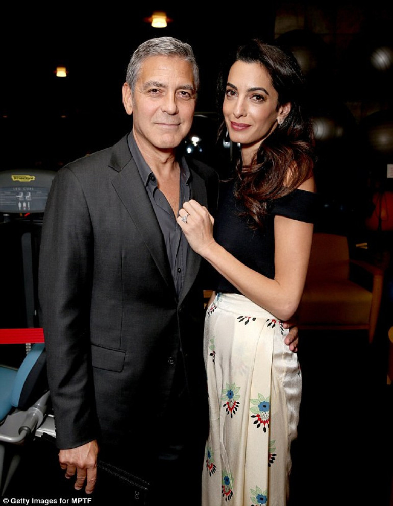 She's smitten! Amal Clooney steals the show as she cozies up to George at star-studded charity fundraiser in LA