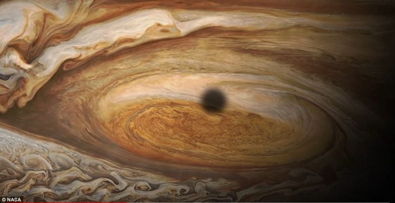 Stunning image captured by NASA's Juno spacecraft reveals a massive storm raging over 'rose-colored Jupiter'