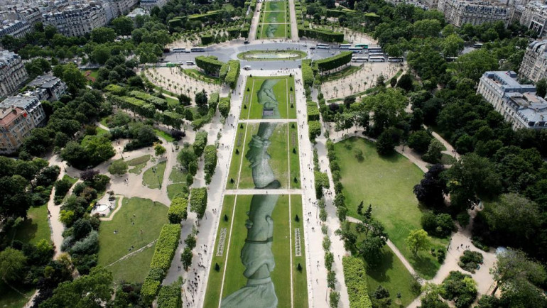 Huge painting unveiled near Eiffel Tower to support migrant rescuers