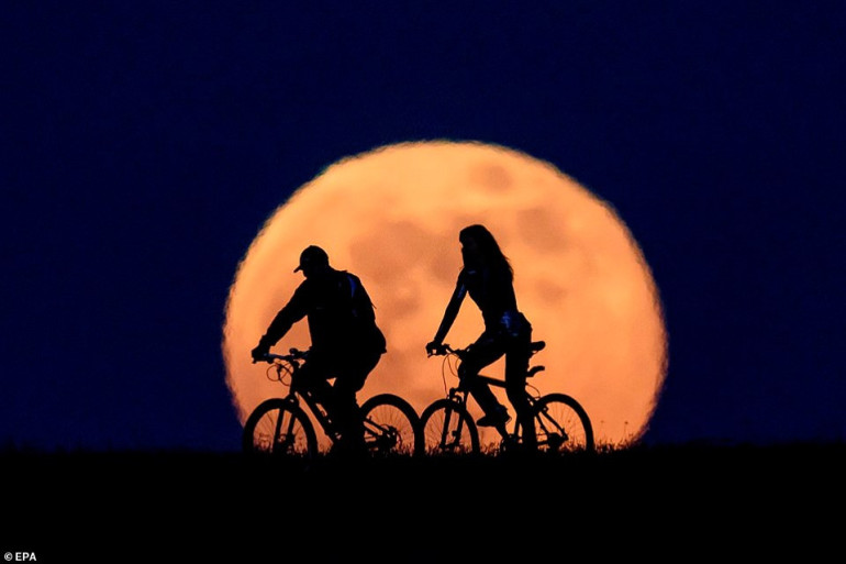 That was super, moon: Sky watchers are transfixed as 'Flower moon' rises putting on a stunning display around the world