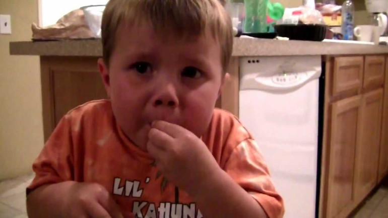 Three year old eating warhead candy